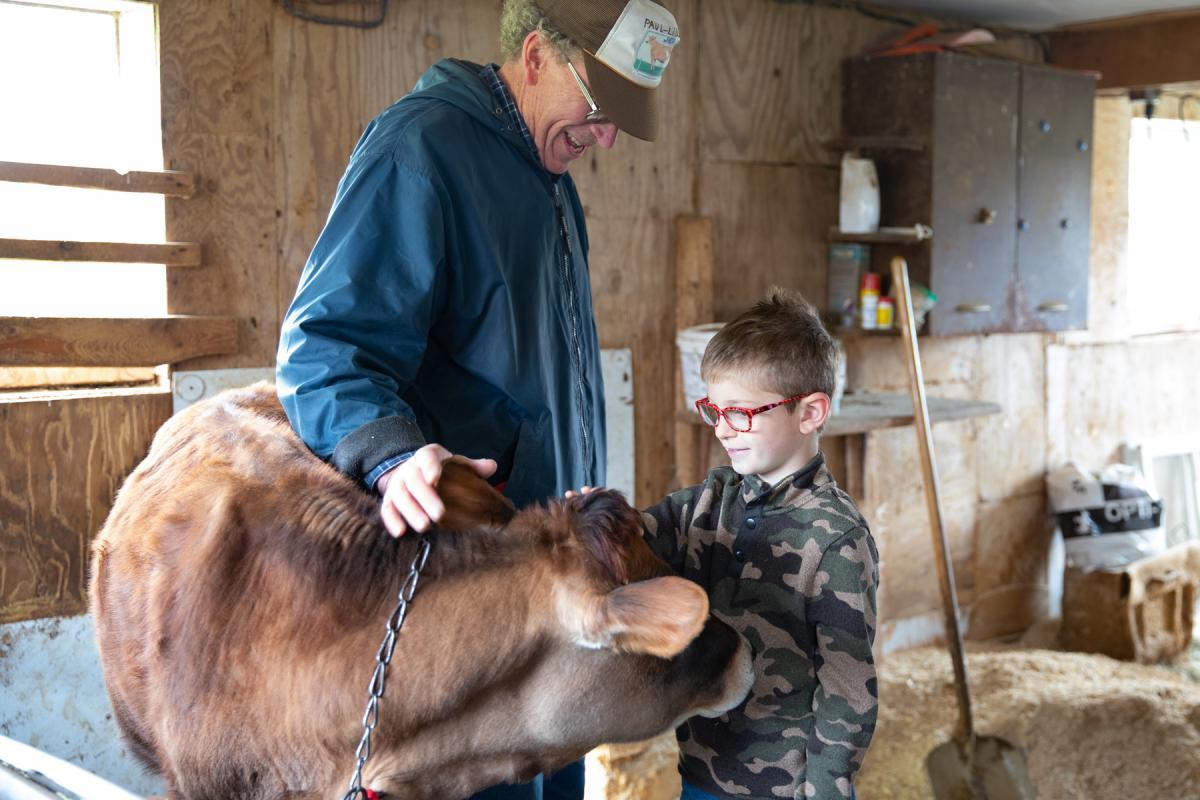 Farmer and Owner Paul Stanley leads students through the calf barn, teaching them about their diet and when they are weaned from milk Farmer and Owner Paul Stanley leads students through the calf barn, teaching them about their diet and when they are weaned from milk
